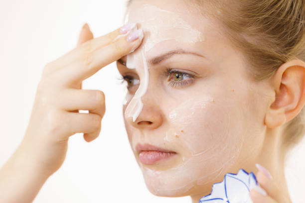 istock Girl apply cream cosmetic 1452485422