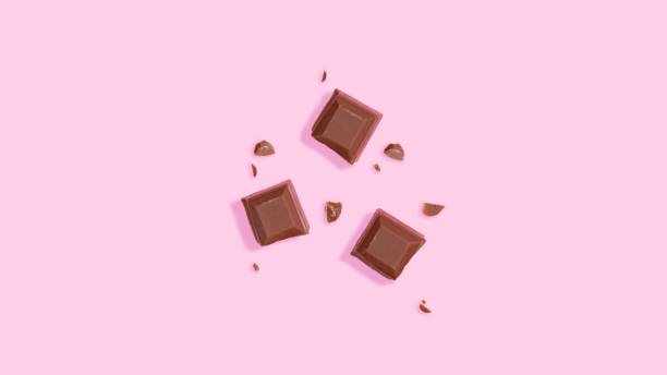 istock Top view of chocolate pieces on a pink background 1452486062