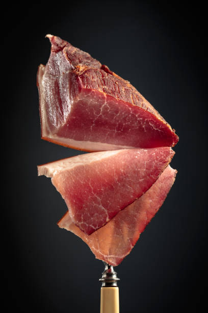 istock Dry-cured pork fillet on a fork. 1452489191