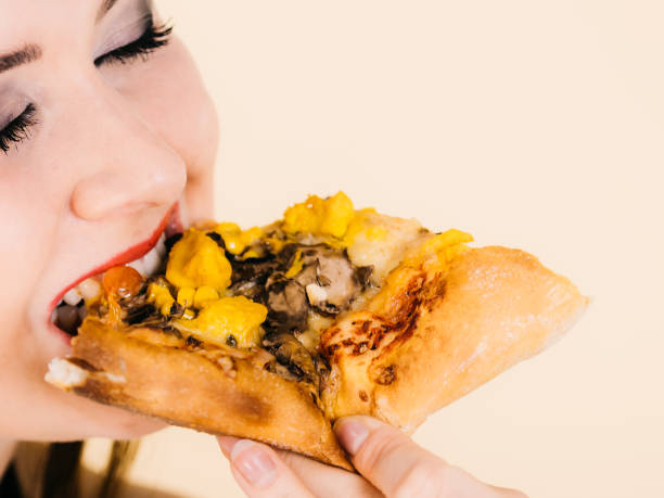 istock Woman eating hot pizza slice 1452490152