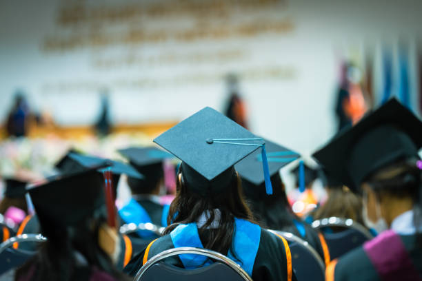 Concept education congratulation and Graduation Ceremony. Congratulated the graduates in University during commencement,backside graduation black hats during commencement success graduates of the university, stock photo