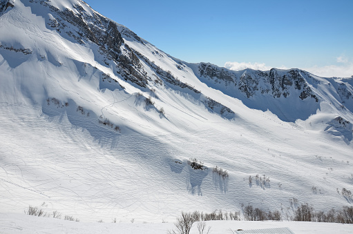 Woman skier skiing at ski resort Amateur Winter Sports. High mountain snowy landscape.  Italian Alps Dolomite ski resort. Madonna di Campiglio Italy . Europe.