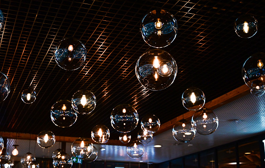 Round-shaped LED lamps on the ceiling in the interior of the restaurant
