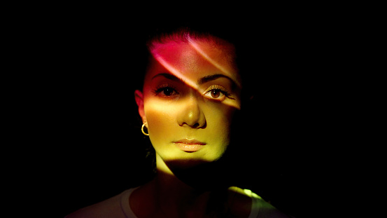 Multicolored lights on a woman's face.
