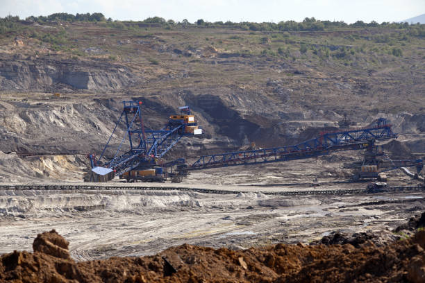 istock Bucket-wheel excavator during excavation at the surface mine. Huge excavator on open pit mine. 1452494011