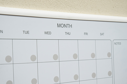 Monthly PLANNER. Empty Magnetic board with the days of the month. Place to enter important matters schedule. Concept for business planning. Whiteboard Planner magnetic monthly template. Interior of freelancer workplace