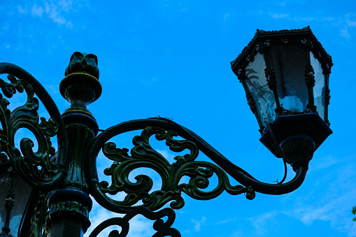 Typical Street Lamp in Malioboro with blue sky background and white cloud. Retro style green street lamp post on Malioboro street. Vintage lamp on Historial City of Yogyakarta.