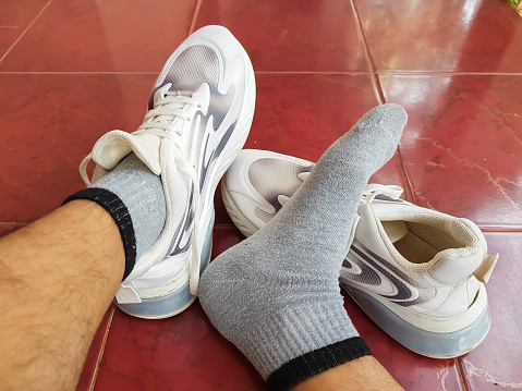 image of people's feet resting wearing sports shoes and socks