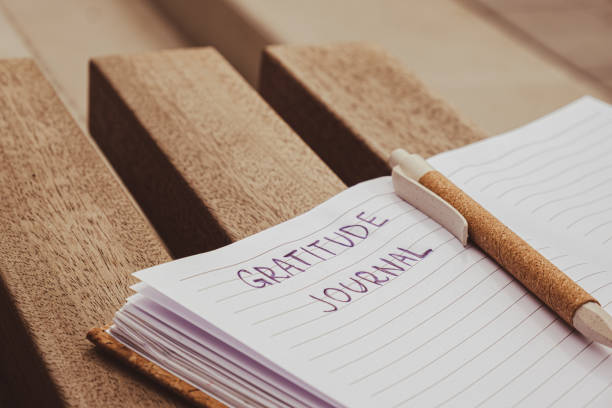 istock Writing Gratitude Journal on wooden bench. Today I am grateful for. Self discovery journal, self reflection creative writing, self growth personal development concept. Wellbeing spiritual health, being mindful, holistic health practices 1452499408