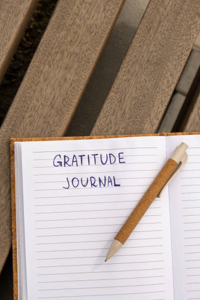 istock Writing Gratitude Journal on wooden bench. Today I am grateful for. Self discovery journal, self reflection creative writing, self growth personal development concept. Wellbeing spiritual health, being mindful, holistic health practices 1452499431