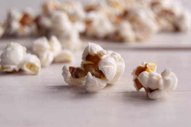 istock Popcorn on white wooden table, close up 1452500743