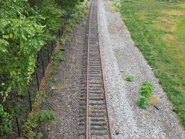 istock High-angle shot of a railroad next to a field 1452500890