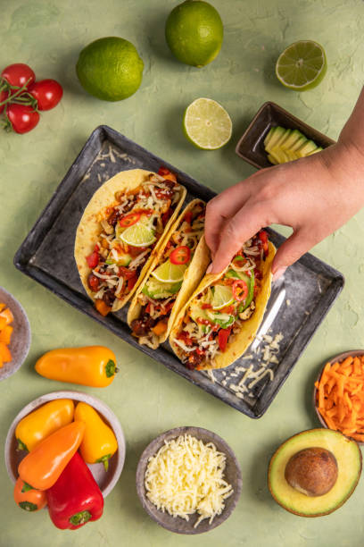Vegan Tacos Wraps Tex Mex food with beans, avocado, roast cauliflower and vegetables stock photo