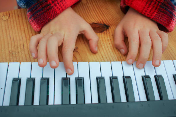 istock learning to play piano in a toy keyboard 1452503762