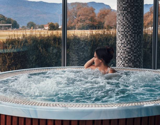 istock White female taking a therapy bath in a hot tub and looking out 1452503968