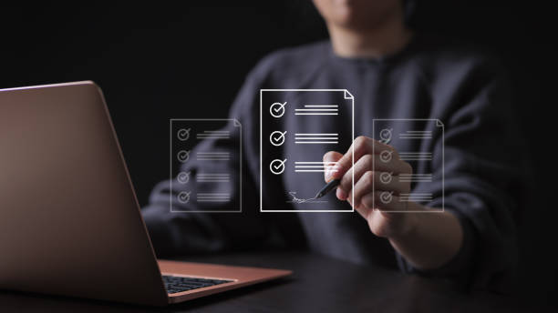 istock E-document management Paperless workplace. Online business contract Electronic signature concept. e-signing, businesswoman signs an electronic document on virtual screen using a pen. 1452505199