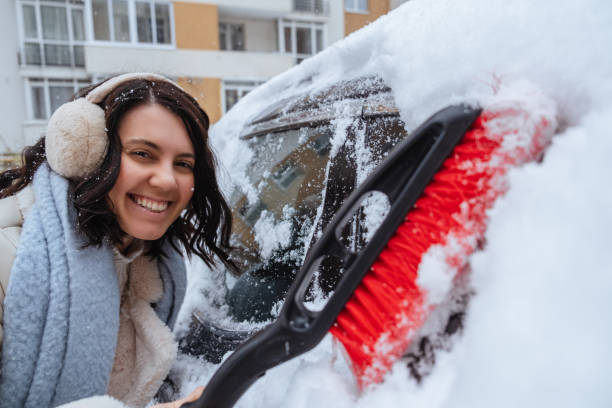istock Winter is approaching, snowfall is forecast. A woman cleans the car from snow 1452509553