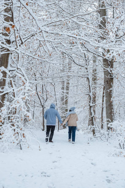istock Running in a winter forest with a couple in love 1452509571