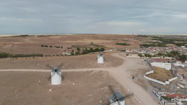 Aerial shot as flying over a historical landscape, the white mills of Campo de Criptana.