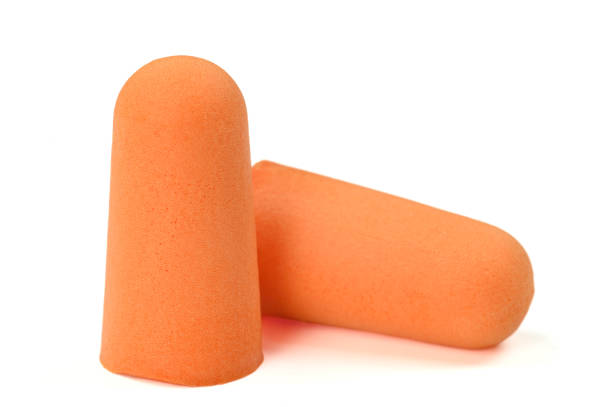 istock Orange earplugs highlighted on a white background.Close-up.Soft foam earplug 1452513006