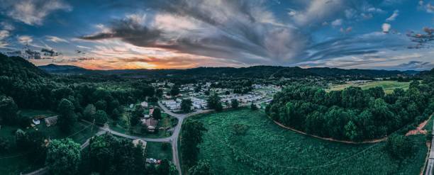 istock Panoramic view of forested hills under a cloudy sunset sky 1452514367