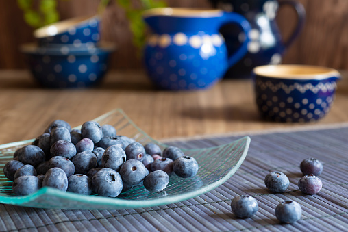 Blueberries in glass plate on a table with decoration