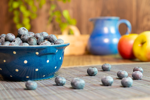 Blueberries in glass plate on a table with decoration