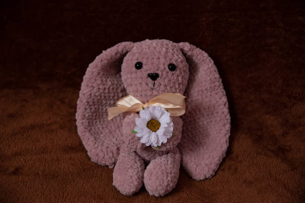istock delicate pink knitted bunny with a chamomile flower 1452517030