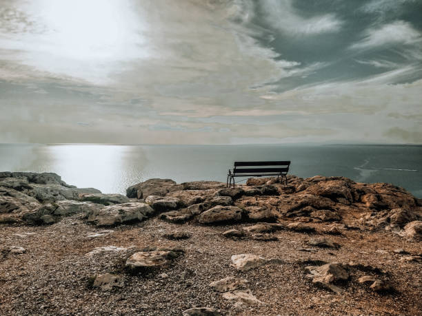 istock An empty bench on a cliff. Summer sunny landscape. Mediterranean Sea coast, Cavo Greco, Cyprus. 1452518735