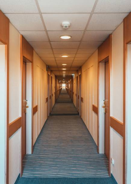 An empty hotel hallway with wooden doors