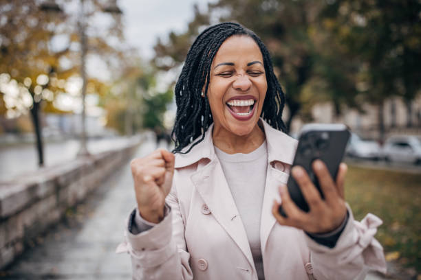 istock Happy woman using smart phone 1452522336