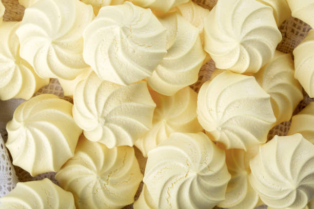 istock French meringue cookies, yellow twisted crispy meringue as background. 1452522671