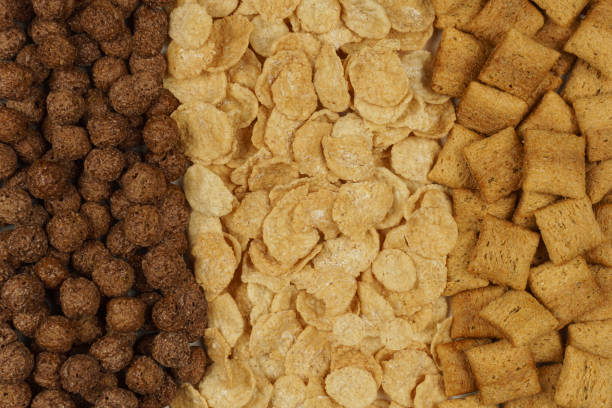 istock Background and texture of breakfast cereals: corn flakes, chocolate balls, pads 1452527300