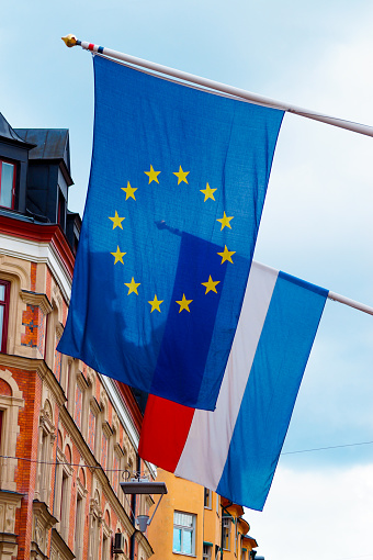 Low angle view of european union flag and the Flag of the Netherlands