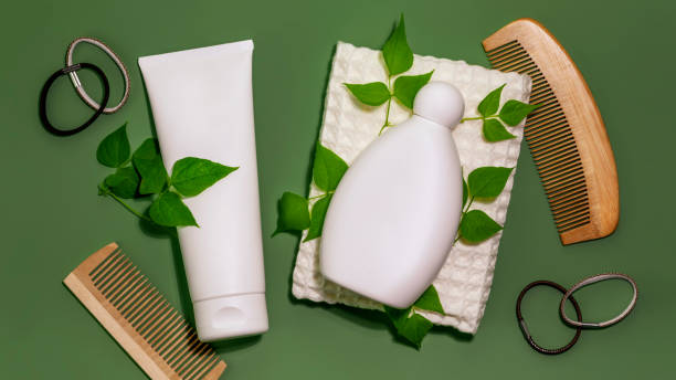 istock Shampoo and conditioner bottles with combs on a green background 1452527751