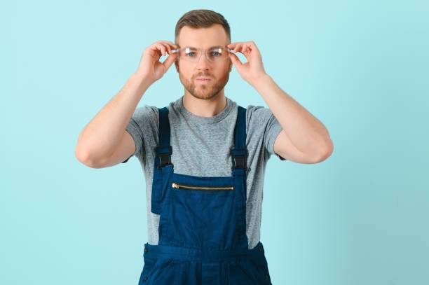 istock Portrait of a friendly worker. Isolated on blue 1452533382