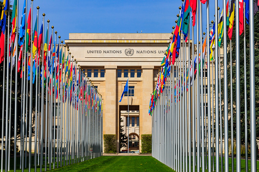 Geneva, Switzerland -April 11, 2022: Rows of the United Nations member states flags in a front of Palace of United Nations in Geneva, Switzerland