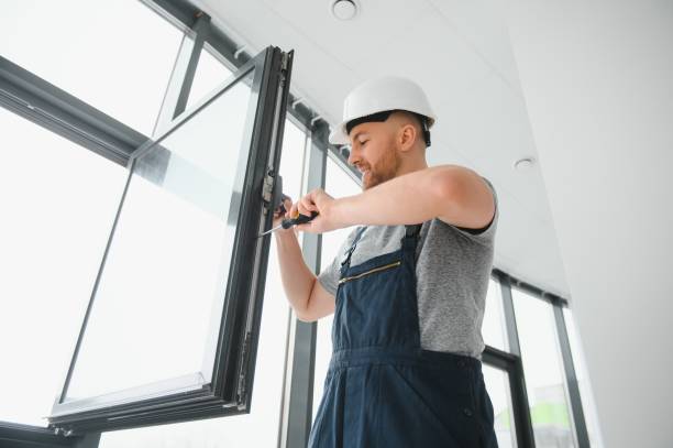 istock handsome young man installing bay window in new house construction site 1452534455
