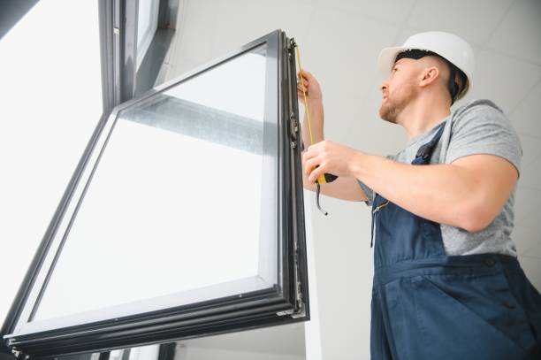 istock handsome young man installing bay window in new house construction site 1452534587