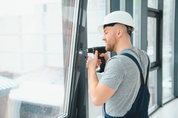 istock handsome young man installing bay window in new house construction site 1452534783