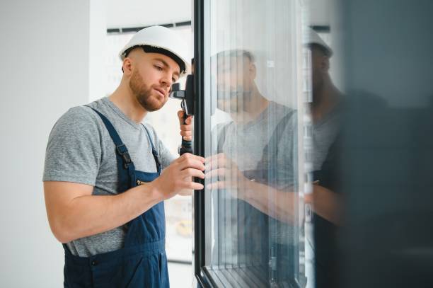 istock handsome young man installing bay window in new house construction site 1452534804