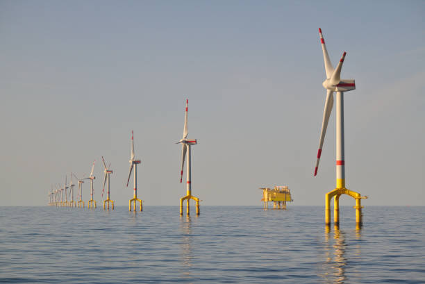 offshore wind turbine and platform offshore wind turbine field with transformer platform offshore wind farm stock pictures, royalty-free photos & images