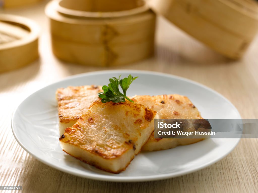 Pan-Fried Carrot Cake served in dish isolated on table top view of food Turnip Cake Stock Photo