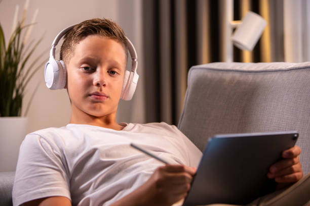 istock He is relaxing and drawing on his i pad 1452542217