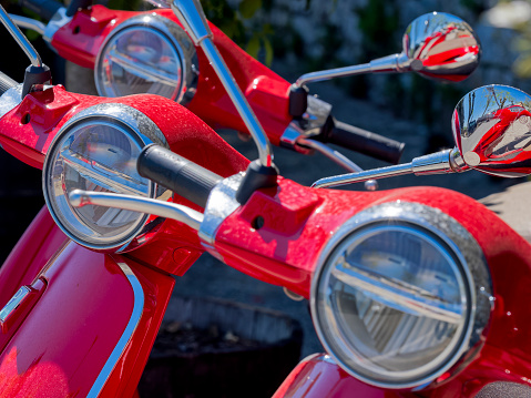 Red Motorbikes parked along a street in the Chianti region of Tuscany Italy town