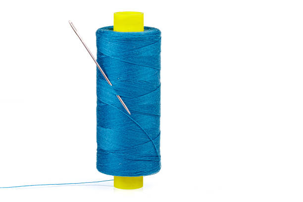 istock Macro skein of blue thread with a needle on a white background 1452543386