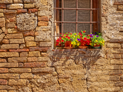 Window features of apartments along the streets of San Gimignano in Tuscany Italy