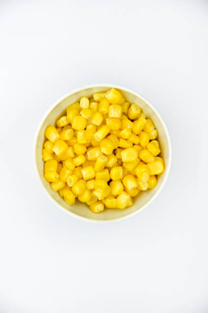 istock Ripe corn on a white plate. Juicy yellow corn. Canned corn salad. 1452547129