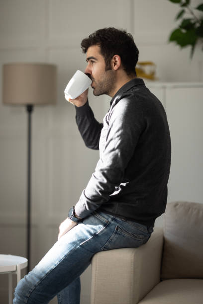 istock Young businessman relaxing on comfortable with cup of coffee. 1452548178