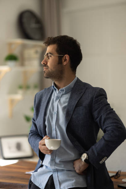 istock Young businessman relaxing on comfortable with cup of coffee. 1452548486